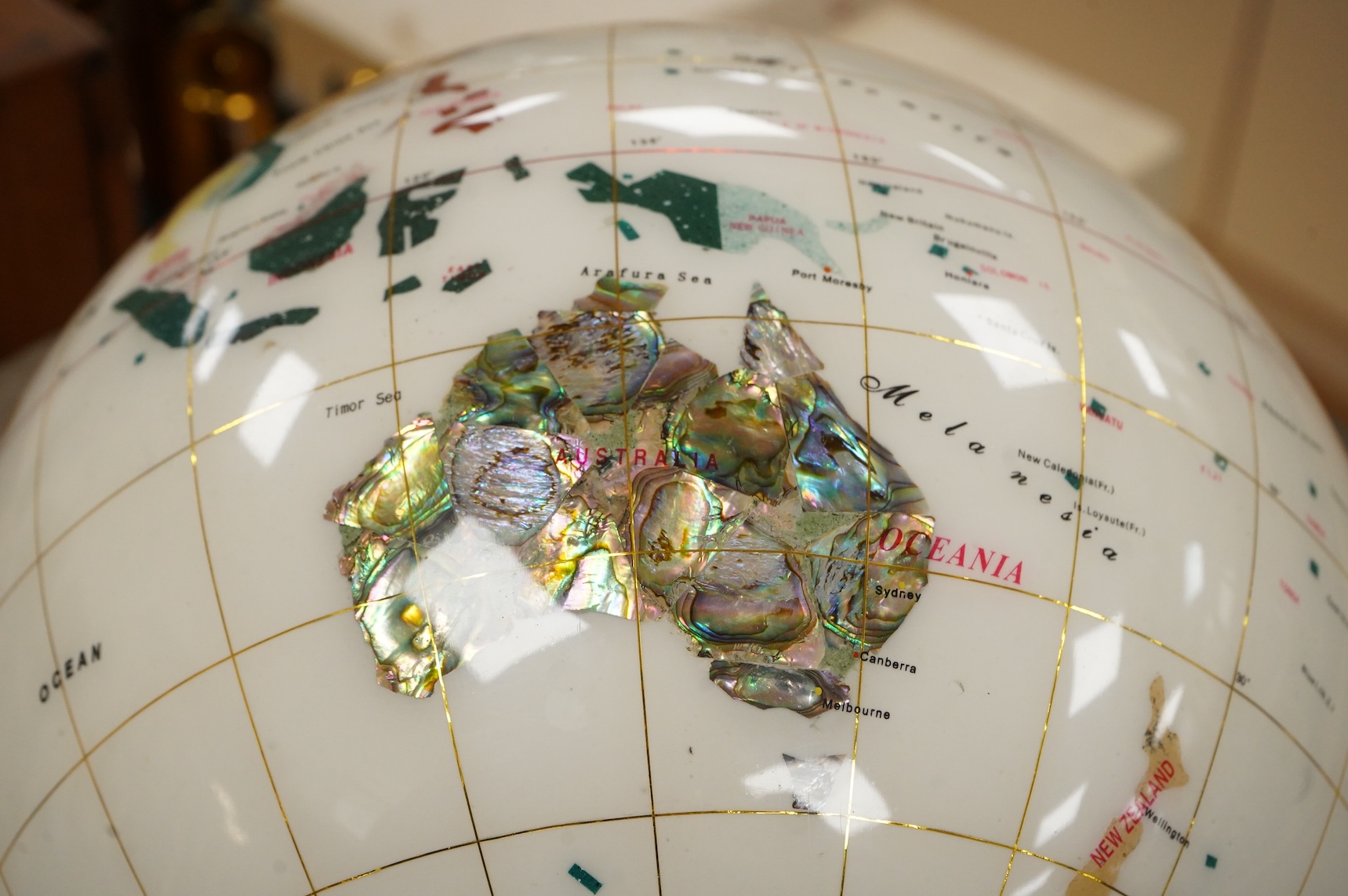 A modern globe on a chromed stand with inset minerals, 12 inch diameter globe